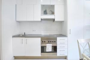 a kitchen with white cabinets and a stove at Your BEST EXPERIENCE in old Madrid - Sol in Madrid