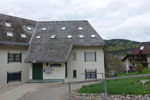 a white house with a gray roof at Zum Schwalbennest in Todtmoos