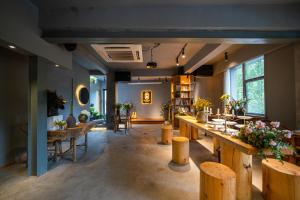 a room with a bar with wooden stools at Moonlight Hotel in Chengdu