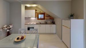 a kitchen with a glass table with a plate on it at Parga Inn Suites in Parga