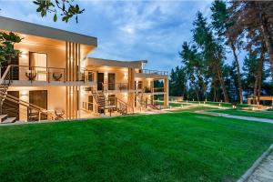 a large house with a lawn in front of it at EOS Luxury Suites in Kriopigi