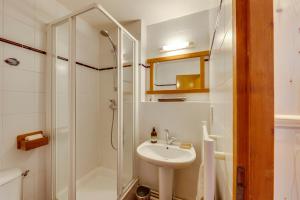 a white bathroom with a sink and a shower at Résidence Studio Sakura in Val dʼIsère +19 photos