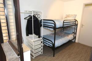 a room with two bunk beds and a closet at Windekind V1 in Blankenberge