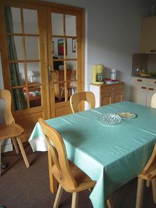 a kitchen with a table with a blue table cloth at Col de Rousset - App. 2 P in Rousset