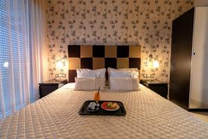 a tray with a plate of food on a bed at Ionian Pearl Luxury Spa Villa in Mesongi +40 photos