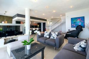 a living room with a couch and a table at Ionian Pearl Luxury Spa Villa in Mesongi