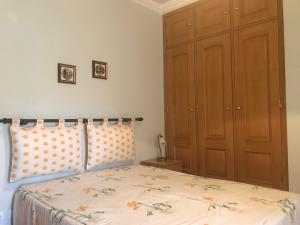 a bedroom with a bed with polka dot pillows at Atlantic Waves Accommodation in Carcavelos