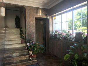 a hallway with potted plants and stairs in a building at Atlantic Waves Accommodation in Carcavelos