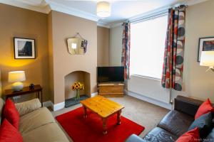 a living room with a couch and a table at AIRE VUE - Skipton in Skipton