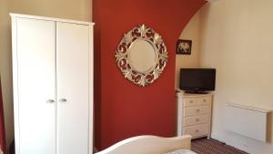 a bedroom with a mirror on the wall and a dresser at Sweet Dreams Residence, close to Penny Lane in Liverpool