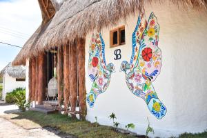 a house with a painting on the side of it at Soho Boutique Holbox - Adults Only in Holbox Island