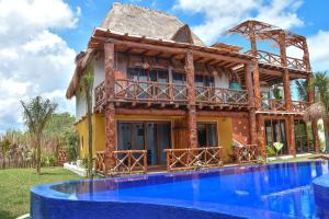 a house with a pool in front of it at Soho Boutique Holbox - Adults Only in Holbox Island