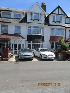 two cars parked in front of a building at Valdene Hotel in Paignton