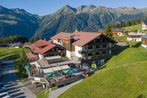 an aerial view of a hotel with mountains in the background at T3 Alpenhotel Garfrescha in Sankt Gallenkirch