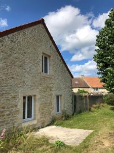 an old stone house with two windows at Gite Bord de Mer 80 m2 in Bernières-sur-Mer