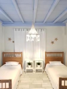 Postel nebo postele na pokoji v ubytování Mare Mare Mykonos