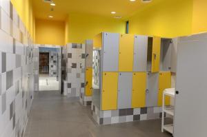 a room with yellow and white lockers and a hallway at Apartament Victoria 5 Mórz in Sianozety +13 photos