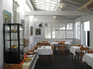 a dining room with tables and chairs in a restaurant at Hotel Barnetche in Biarritz