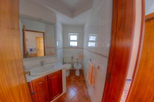a bathroom with a sink and a toilet at Casa da Ria Formosa in Cabanas de Tavira +8 photos