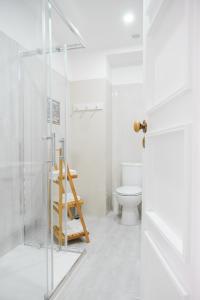 a bathroom with a toilet and a glass shower at 4U Lisbon Suites & Guesthouse VII Airport in Lisbon +45 photos