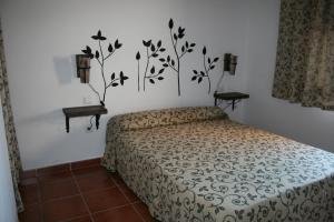 a bedroom with a bed and two side tables at Casa Rural La Posada Del Frances in Villarrubia de Santiago