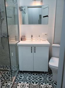 a bathroom with a sink and a shower and a toilet at Tatiana Gudauri in Gudauri +9 photos