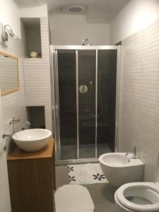 a bathroom with a shower and a sink and a toilet at cascina Filura in Mango +16 photos