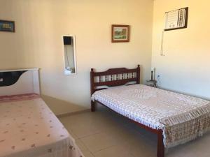 En eller flere senger på et rom på Casa de Praia 4qtos em Saquarema!