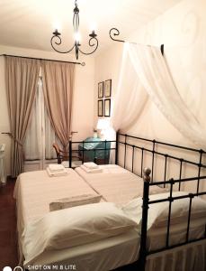 two beds in a bedroom with curtains and a chandelier at Casa Sierra Norte Madrid in Lozoya +43 photos