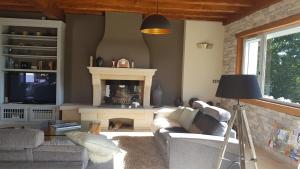 a living room with a couch and a fireplace at Maison d hotes Lapitxuri in Arcangues