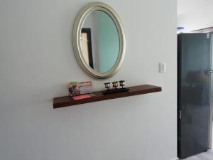 a mirror on a wall next to a shelf at Edificio Nancabez III in Tonsupa +12 photos