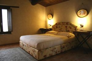 ein Schlafzimmer mit einem Bett und zwei Lampen an der Wand in der Unterkunft La Corte De' Vasari in Bevagna