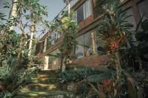 a brick house with stairs leading up to it at Pousada Estação Baleia in Praia do Rosa