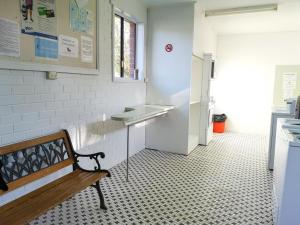 a kitchen area with a bench and a refrigerator at BIG4 Warrnambool Figtree Holiday Park in Warrnambool