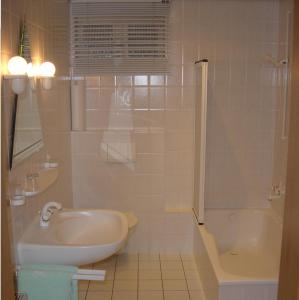 a bathroom with a sink and a toilet and a shower at Landgasthof Schuck in Idar-Oberstein