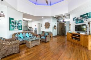 a living room with couches and a flat screen tv at Pura Villa in Sanur