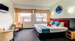 a hotel room with a bed and a window at Ascotia Off Queen in Auckland