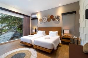Postel nebo postele na pokoji v ubytování Annupuri Villas Bali