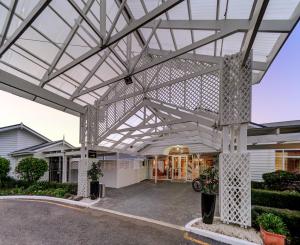 a metal pergola over the entrance to a building at VR Rotorua Lake Resort in Rotorua