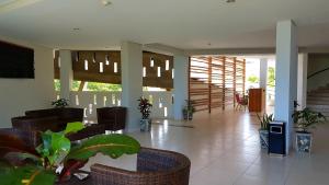 a lobby with a table and chairs in a building at Luwansa Beach Hotel in Labuan Bajo