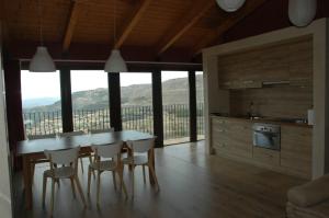 a kitchen with a table and chairs with a view at Casa Rural Virginia in Ares del Maestre