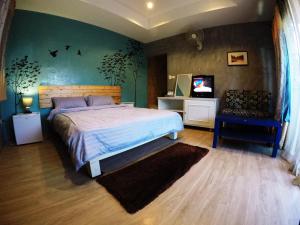 a bedroom with a bed and a television in it at Payi Resort in Pai