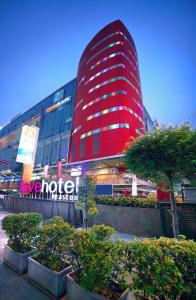 a large red building with a sign in front of it at favehotel LTC Glodok in Jakarta