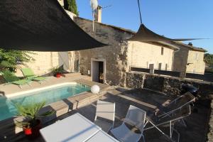 a villa with a swimming pool in front of a building at The Panoramic House in Lagnes