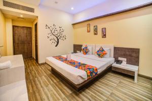 a bedroom with a bed in a room at FabHotel Bee Town in Indore