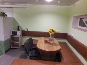 a room with a table and chairs in a room at Hotel Katrin in Vinnytsya