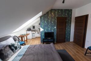 a bedroom with a bed and a living room at Arya vila in Piešťany