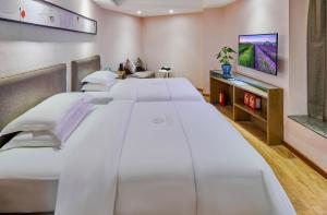Krevet ili kreveti u jedinici u objektu Insail Hotels (Pazhou Exhibition Center KeCun Metro Station Dunhe Road Branch Guangzhou)