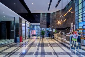 a lobby of a building with a restaurant at Insail Hotels (Pazhou Exhibition Center KeCun Metro Station Dunhe Road Branch Guangzhou) in Guangzhou