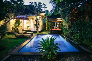 a swimming pool in the yard of a house at Rumah Karda Ubud in Ubud